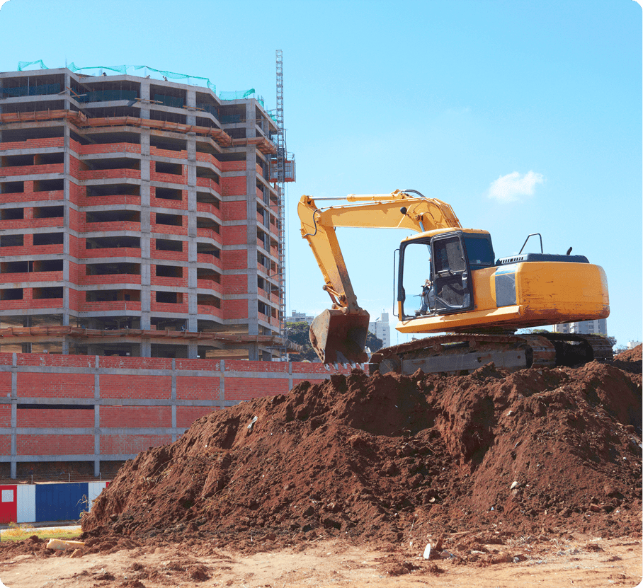 Excavator at construction site near building.